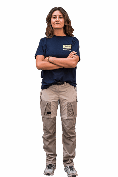 Eine Seenotretterin sieht mit verschränkten Armen und entschlossenem Blick in die Kamera.